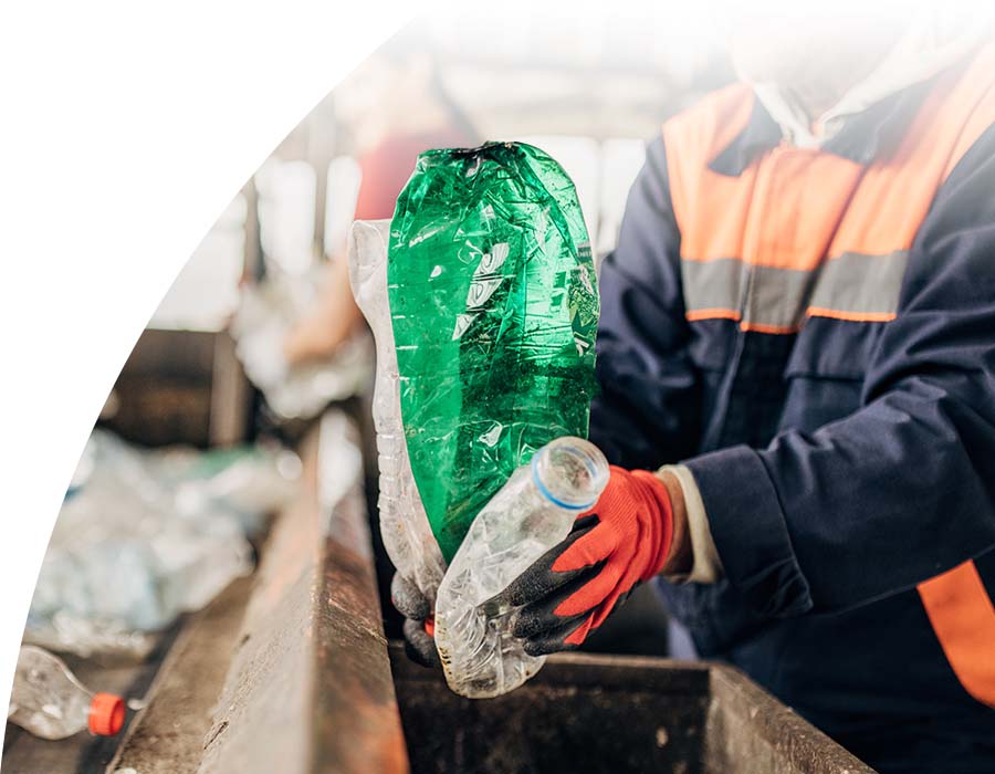 Workers sorting plastic bottles to prepare for recycling