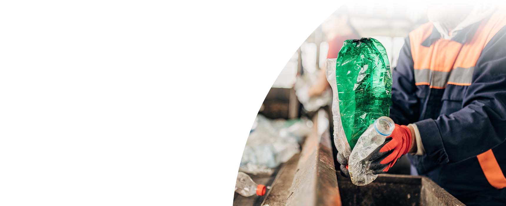 Workers sorting plastic bottles to prepare for recycling